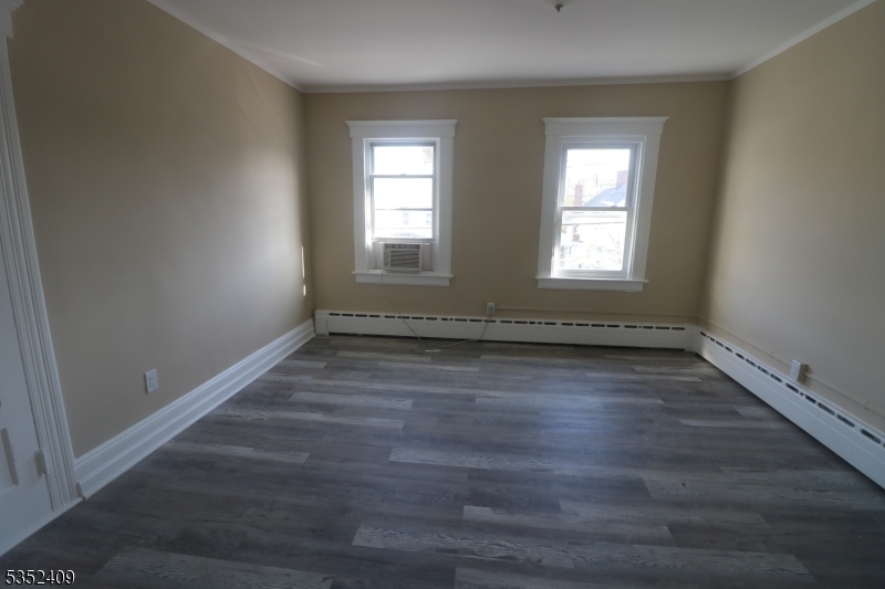 40 Mitchell Street West Orange, NJ 07052 - Photo 3 of 17 an empty room with wooden floor and window