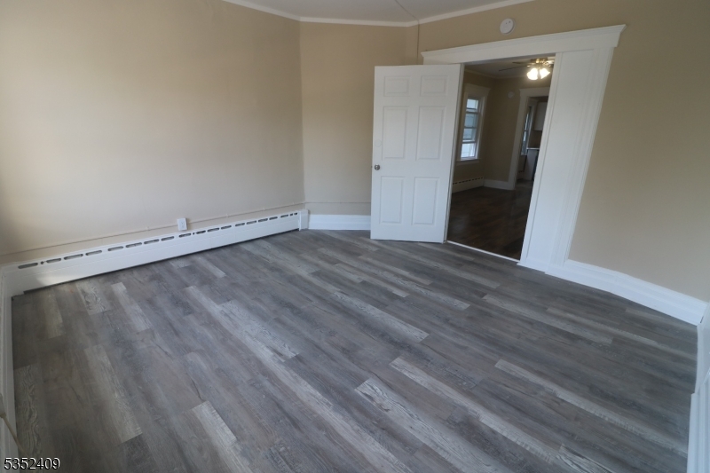 40 Mitchell Street West Orange, NJ 07052 - Photo 5 of 17 a view of an empty room with wooden floor and entryway