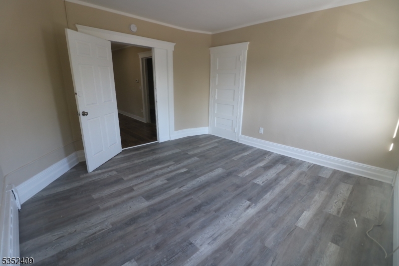 40 Mitchell Street West Orange, NJ 07052 - Photo 6 of 17 a view of an empty room with wooden floor