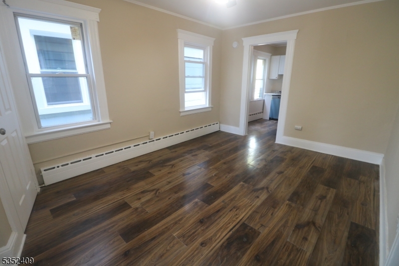 40 Mitchell Street West Orange, NJ 07052 - Photo 7 of 17 an empty room with wooden floor and windows