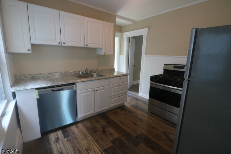 40 Mitchell Street West Orange, NJ 07052 - Photo 10 of 17 a kitchen with a sink stove and cabinets