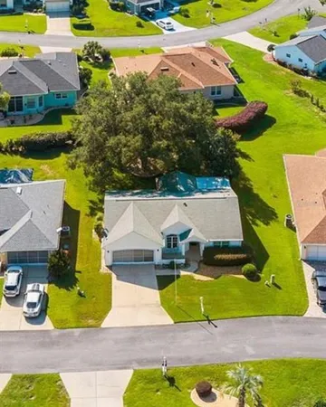 an aerial view of a house with yard swimming pool and outdoor seating