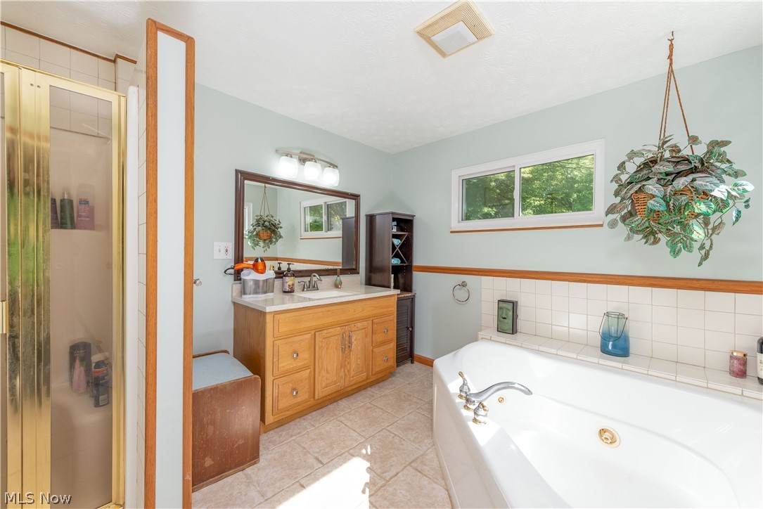 2740 Ranfield Road Mogadore, OH 44260 - Photo 16 of 33 Owners suite....full bathroom with whirlpool tub, walk in shower, ceramic tile flooring.