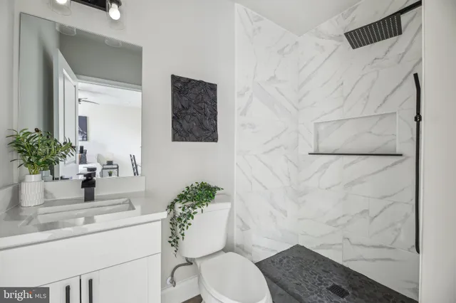 a bathroom with a toilet sink and mirror