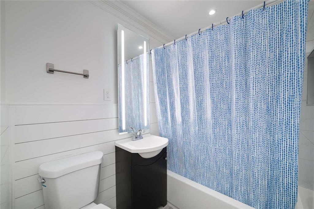 3510 Roswell Road Northwest, Unit M4 Atlanta, GA 30305 - Photo 13 of 23 a bathroom with a sink and a mirror