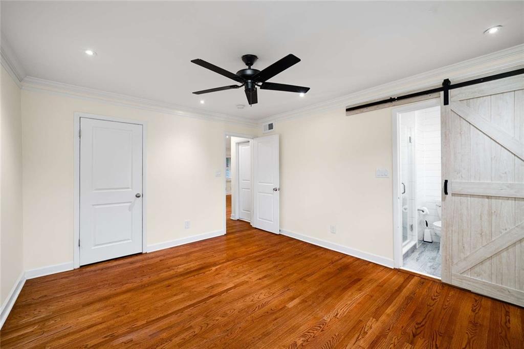 3510 Roswell Road Northwest, Unit M4 Atlanta, GA 30305 - Photo 16 of 23 a view of empty room with wooden floor and fan