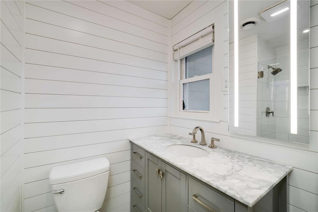3510 Roswell Road Northwest, Unit M4 Atlanta, GA 30305 - Photo 17 of 23 a bathroom with a granite countertop sink toilet and shower