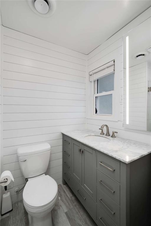 3510 Roswell Road Northwest, Unit M4 Atlanta, GA 30305 - Photo 18 of 23 a bathroom with a granite countertop toilet sink and mirror