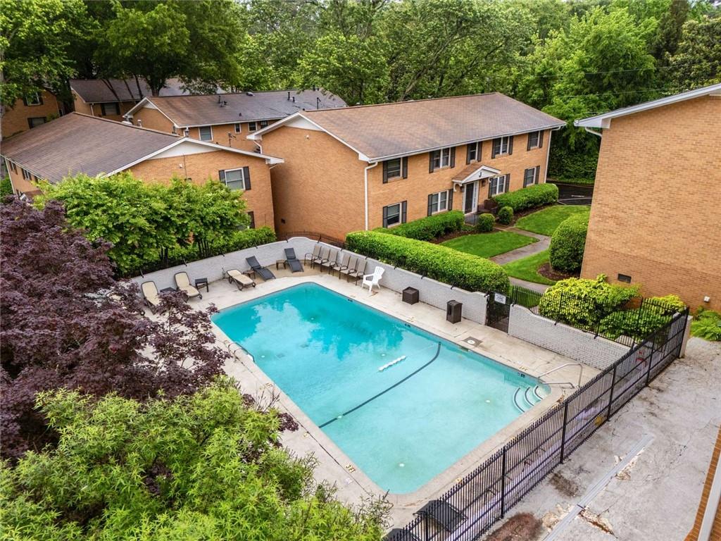 3510 Roswell Road Northwest, Unit M4 Atlanta, GA 30305 - Photo 23 of 23 a view of a white house with a yard table and chairs