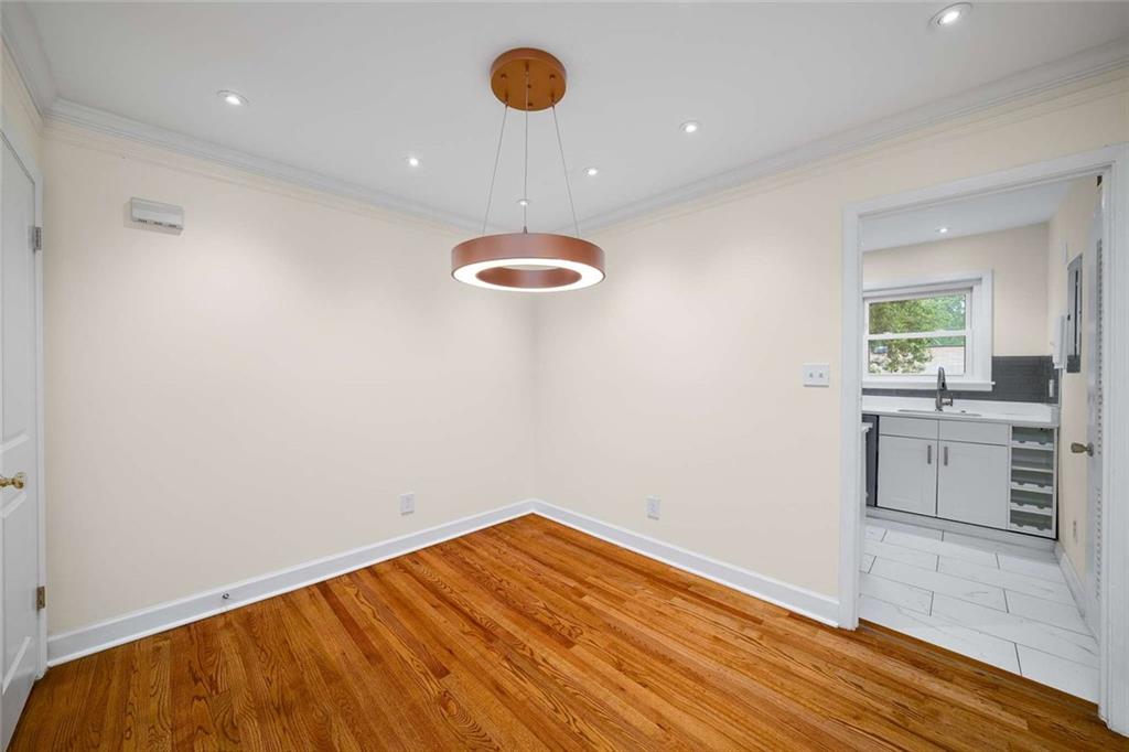 3510 Roswell Road Northwest, Unit M4 Atlanta, GA 30305 - Photo 8 of 23 wooden floor in an empty room with a window