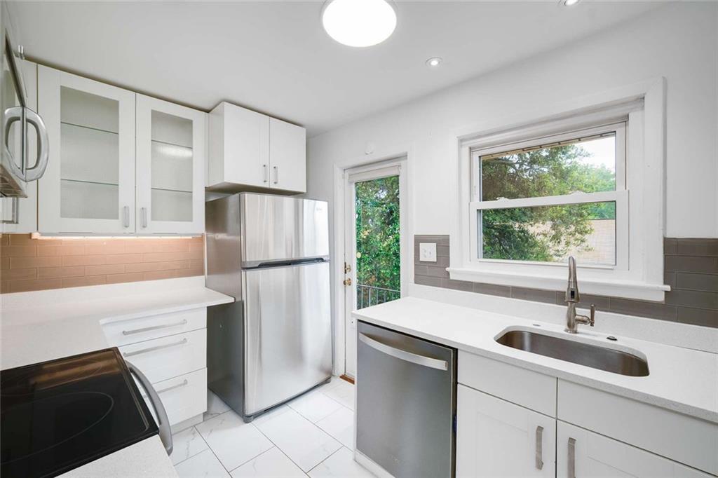 3510 Roswell Road Northwest, Unit M4 Atlanta, GA 30305 - Photo 9 of 23 a kitchen with a sink stove and refrigerator