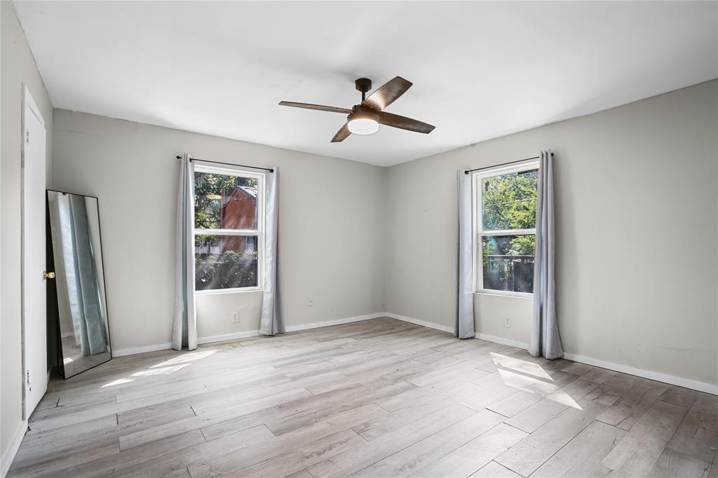 504 Preston Street Waco, TX 76704 - Photo 4 of 14 an empty room with wooden floor and windows
