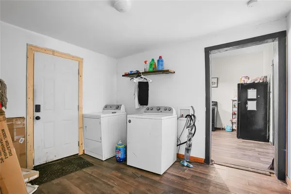 a kitchen with a refrigerator stove and wooden cabinets