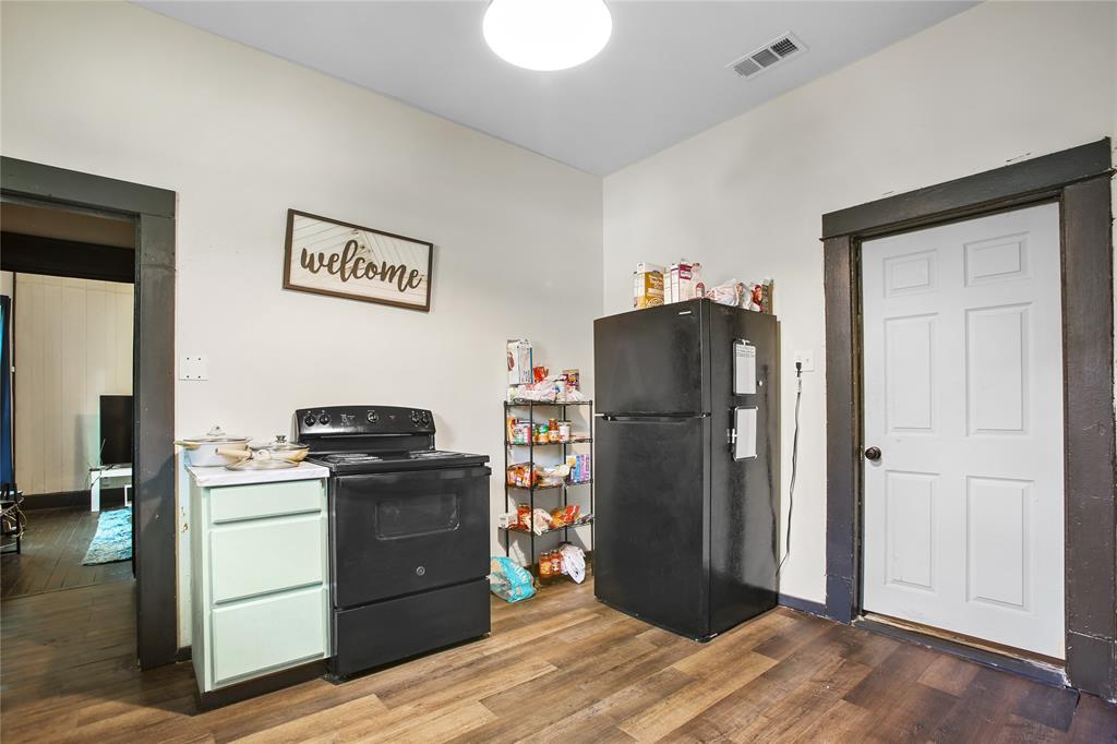 504 Preston Street Waco, TX 76704 - Photo 9 of 14 a kitchen with a refrigerator stove and wooden cabinets