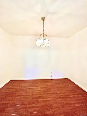 a view of a room with wooden floor and ceiling fan