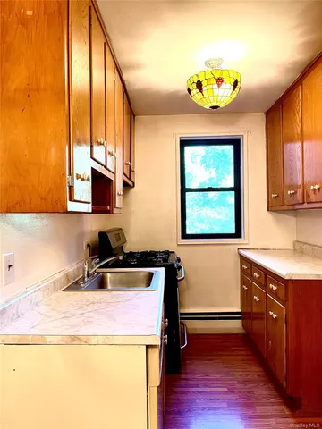a kitchen with a stove a sink and a window