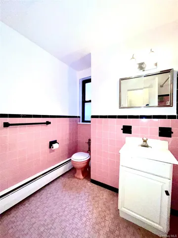 a bathroom with a sink toilet and mirror