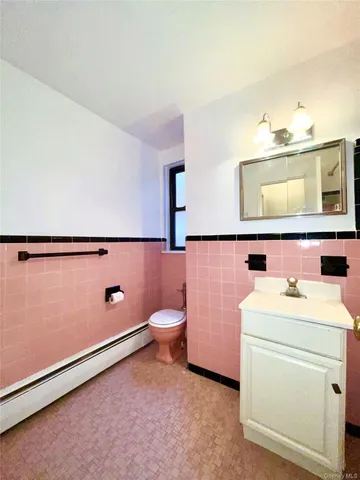 a bathroom with a sink toilet and mirror