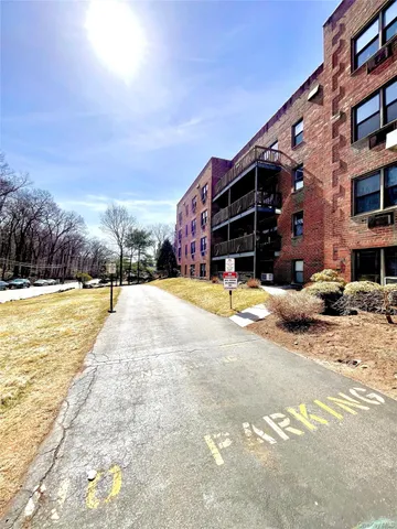 a view of swimming pool with outdoor seating and house in the background