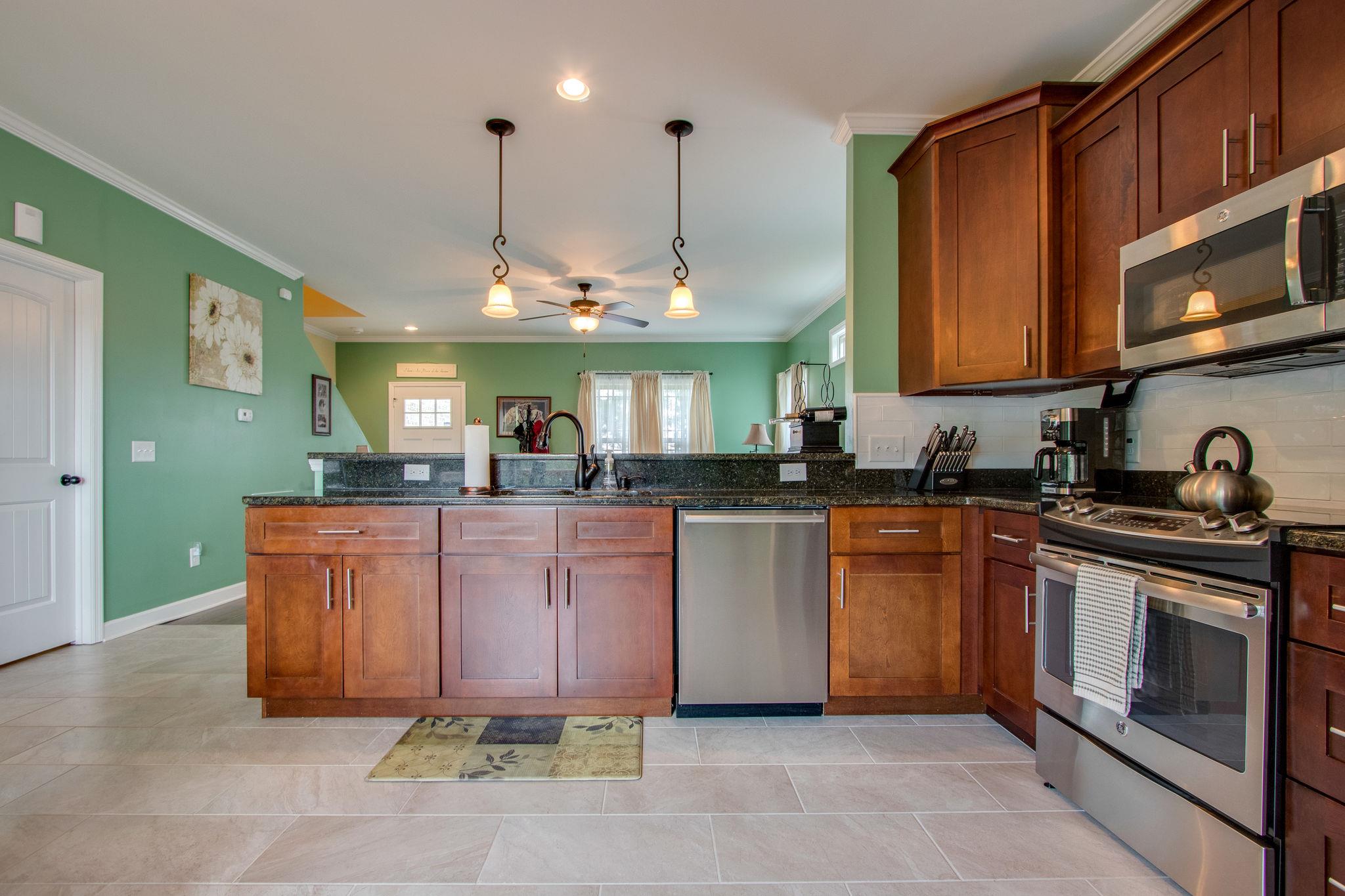 4121 Beasleys Bend Road Lebanon, TN 37087 - Photo 12 of 28 a kitchen with stainless steel appliances granite countertop a stove a sink and a refrigerator