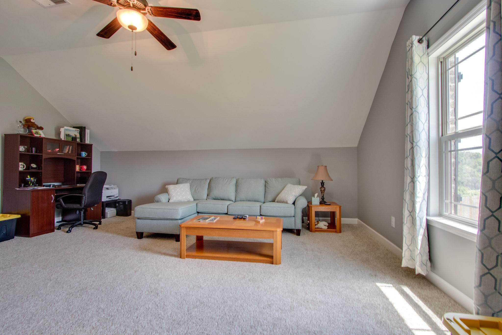 4121 Beasleys Bend Road Lebanon, TN 37087 - Photo 19 of 28 a living room with furniture and a chandelier