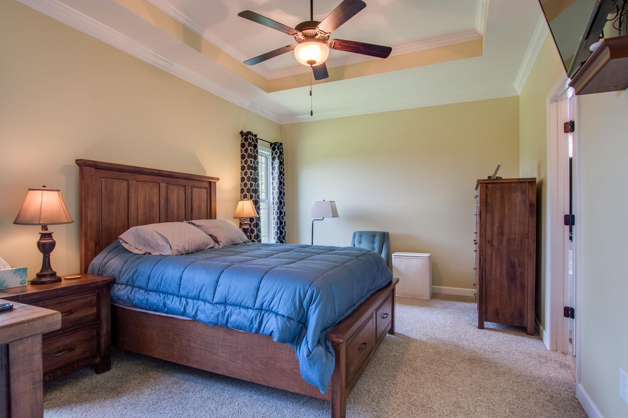 4121 Beasleys Bend Road Lebanon, TN 37087 - Photo 20 of 28 a bedroom with a bed and a chandelier