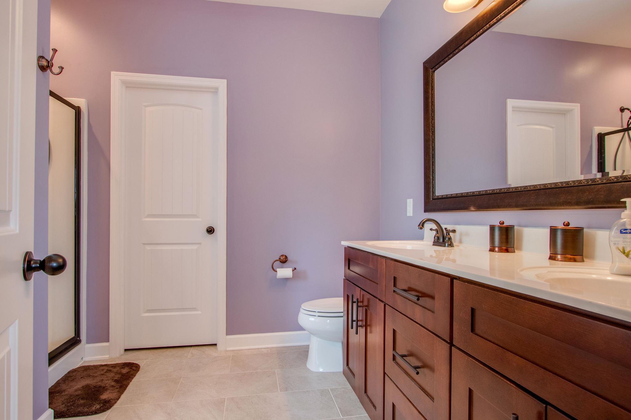 4121 Beasleys Bend Road Lebanon, TN 37087 - Photo 22 of 28 a bathroom with a granite countertop sink a toilet a mirror and shower