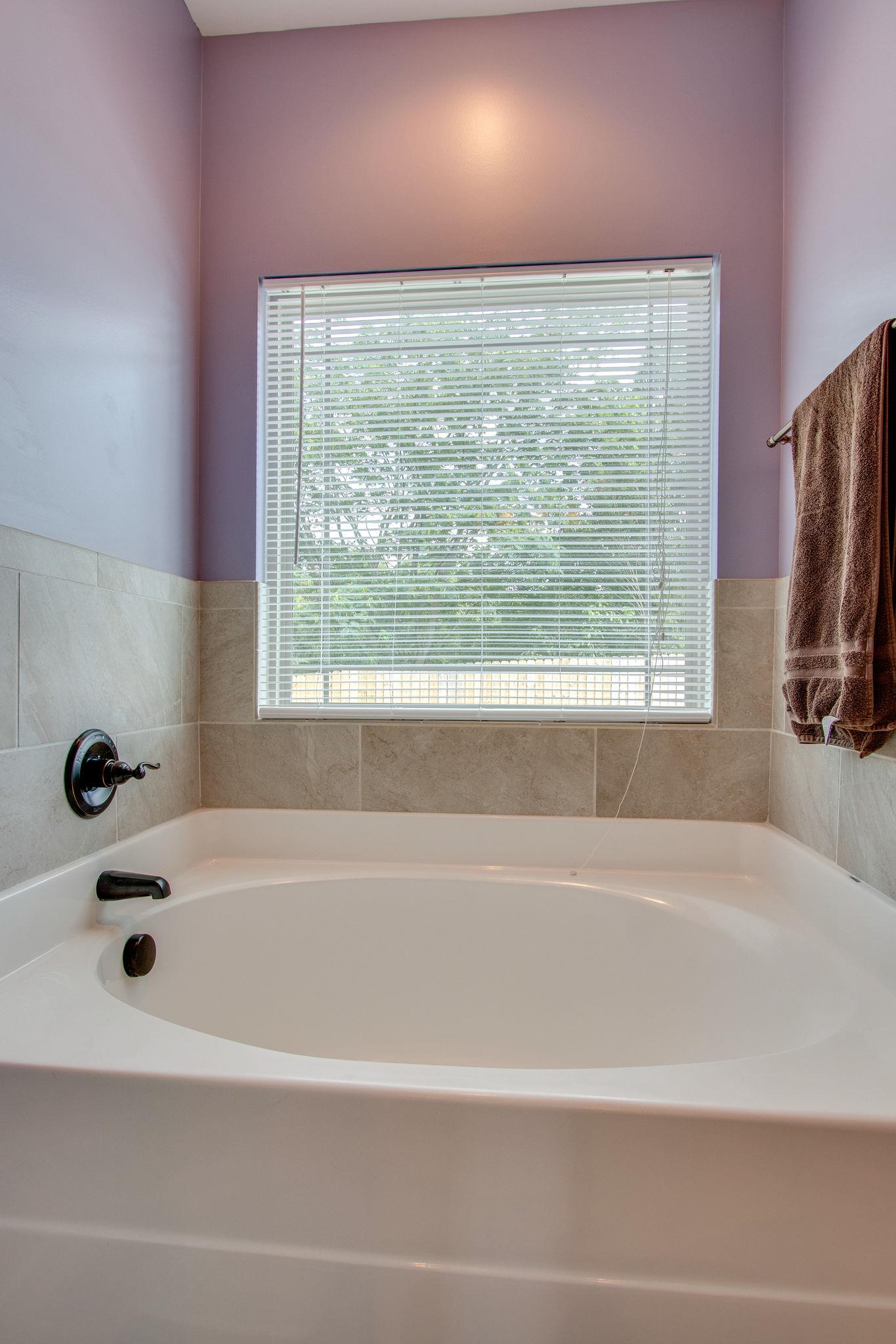 4121 Beasleys Bend Road Lebanon, TN 37087 - Photo 23 of 28 a bathroom with a bathtub and a window