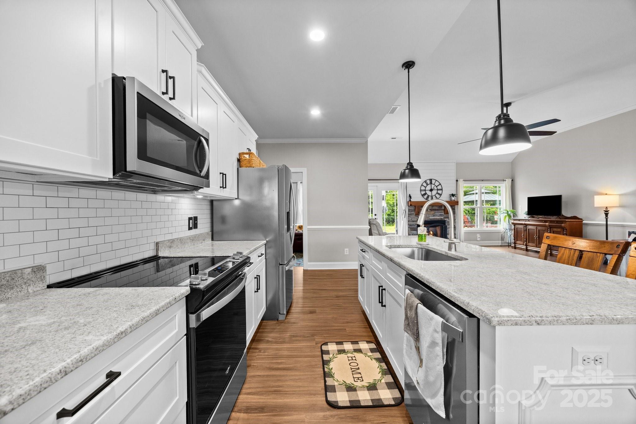 3855 East Holly Grove Road Lexington, NC 27292 - Photo 13 of 42 a large kitchen with stainless steel appliances granite countertop a stove a sink and a microwave