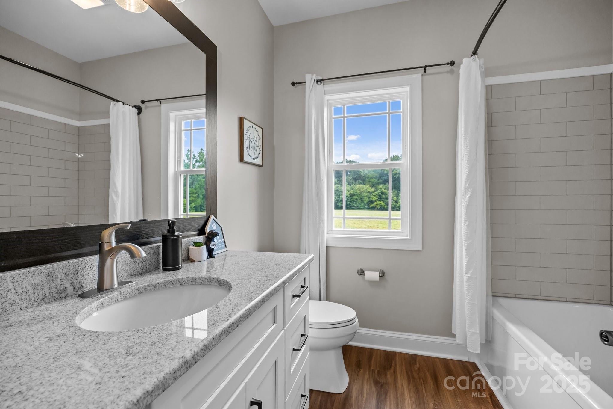 3855 East Holly Grove Road Lexington, NC 27292 - Photo 20 of 42 a bathroom with a granite countertop sink toilet and shower
