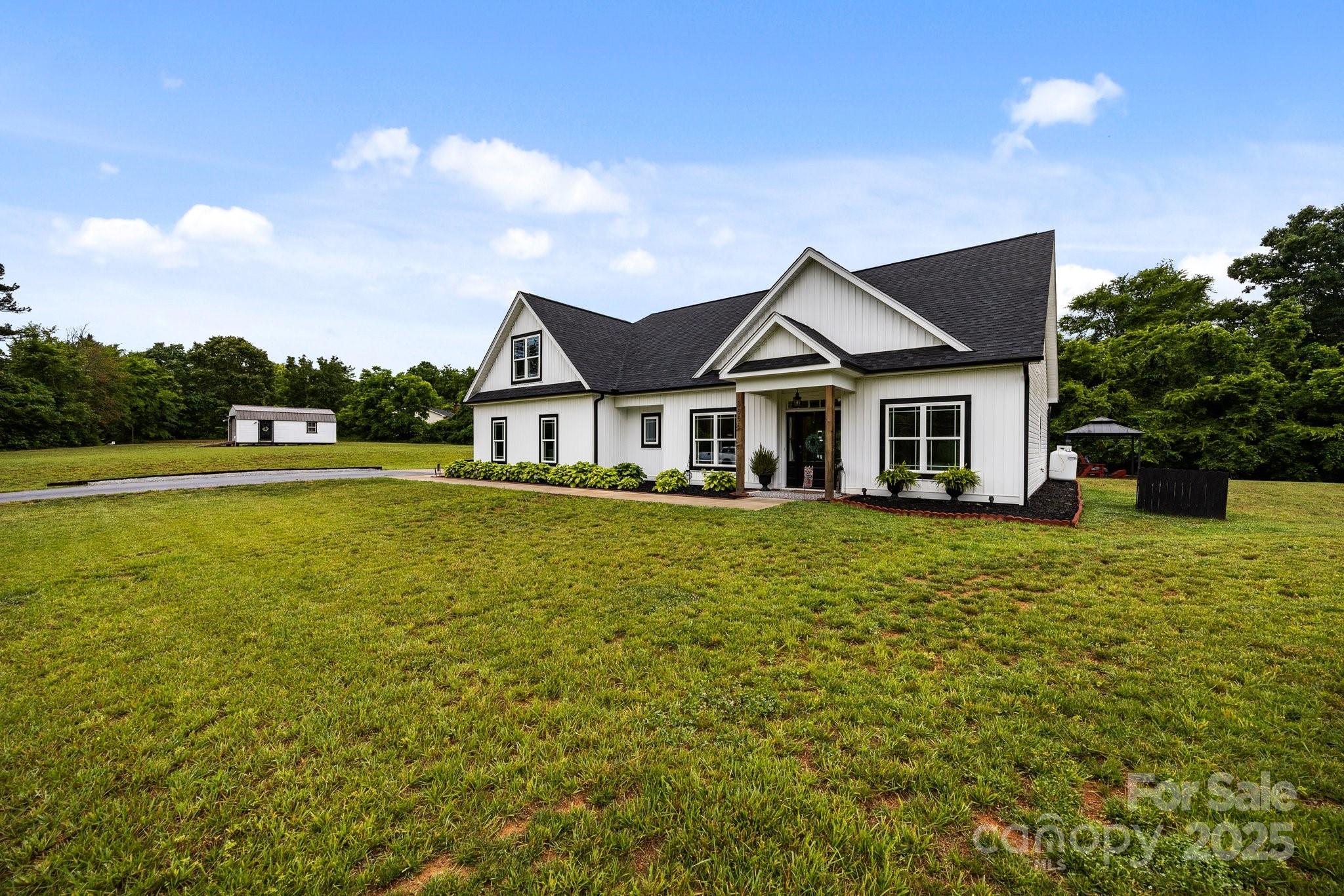 3855 East Holly Grove Road Lexington, NC 27292 - Photo 2 of 42 a front view of a house with a garden