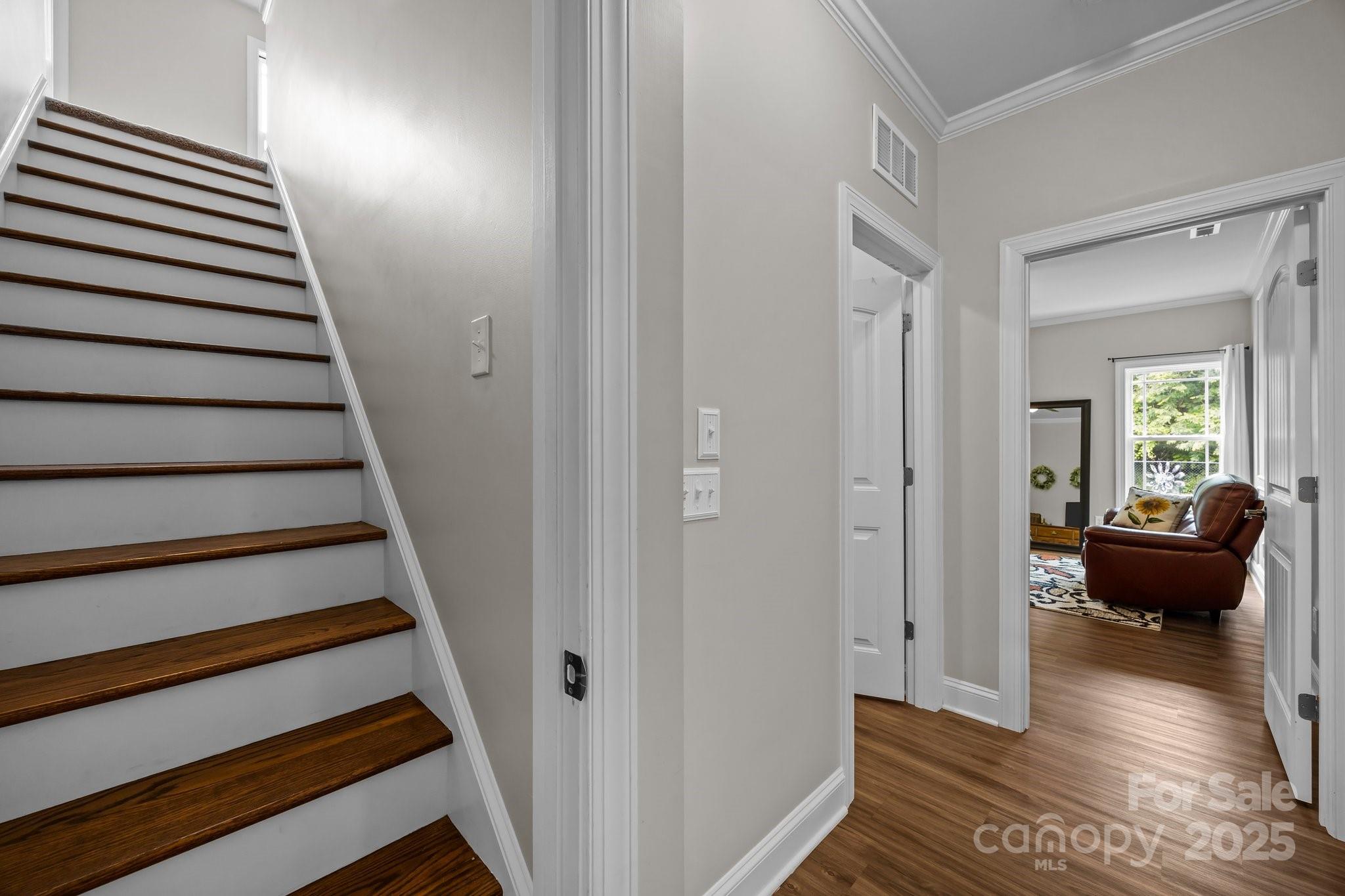 3855 East Holly Grove Road Lexington, NC 27292 - Photo 22 of 42 a view of a hallway to a livingroom with wooden floor and furniture