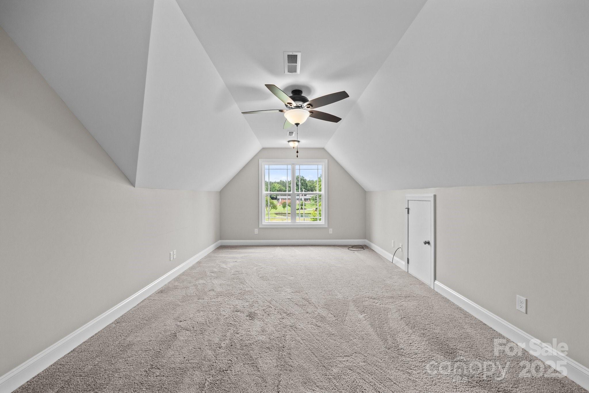 3855 East Holly Grove Road Lexington, NC 27292 - Photo 27 of 42 an empty room with a chandelier fan and windows