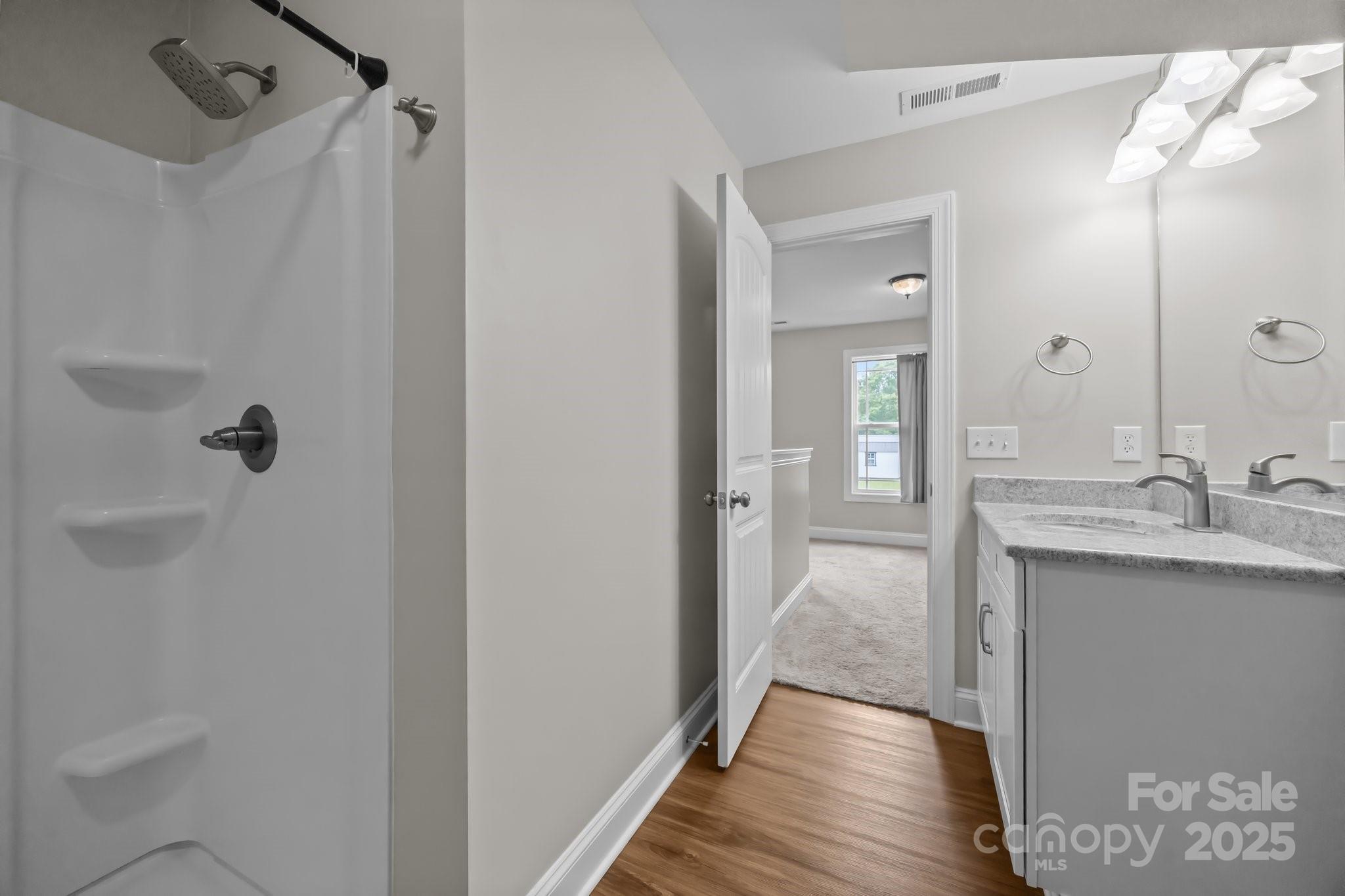 3855 East Holly Grove Road Lexington, NC 27292 - Photo 29 of 42 a bathroom with a granite countertop sink a mirror and a shower