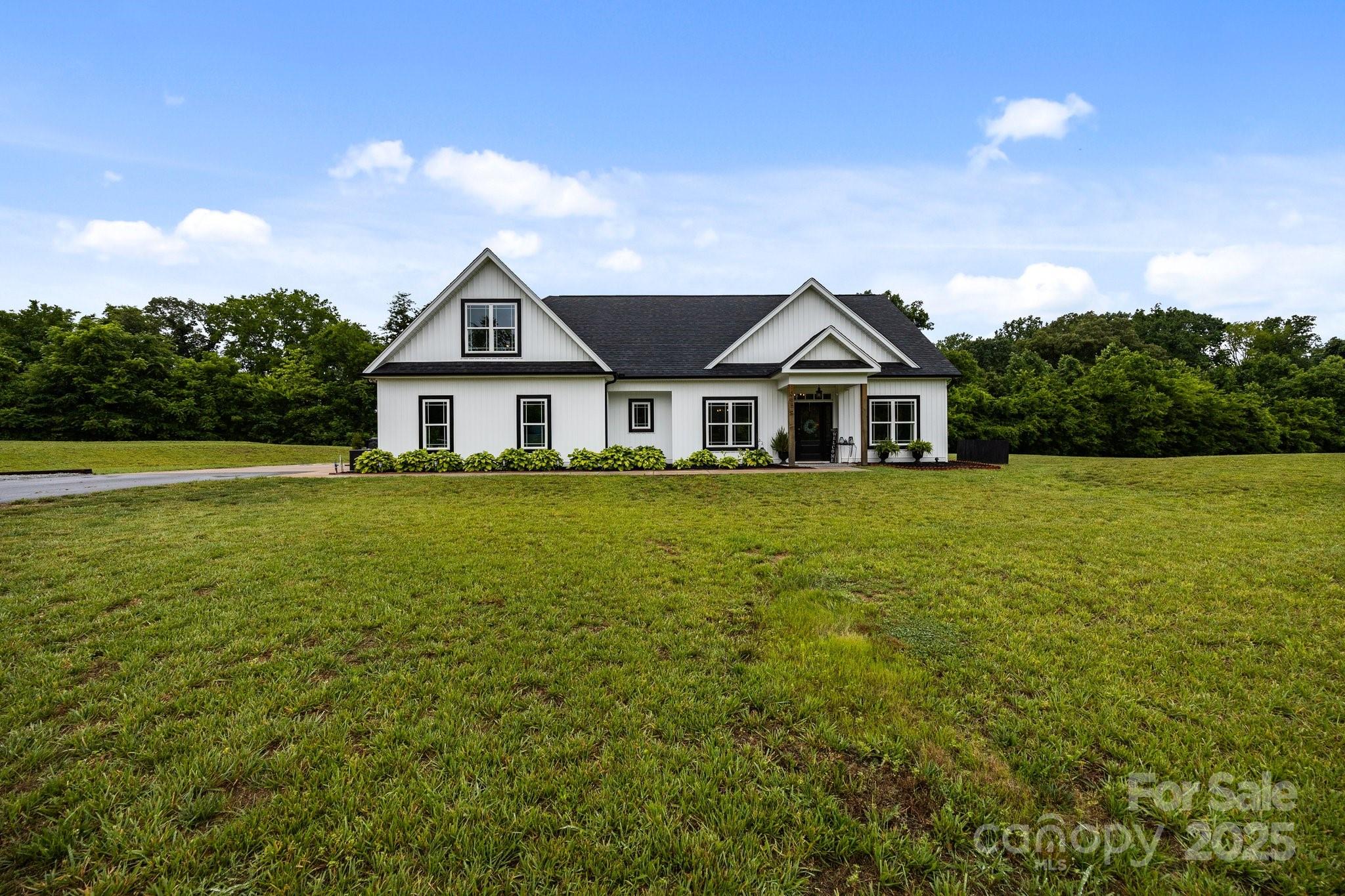 3855 East Holly Grove Road Lexington, NC 27292 - Photo 3 of 42 a front view of a house with a big yard