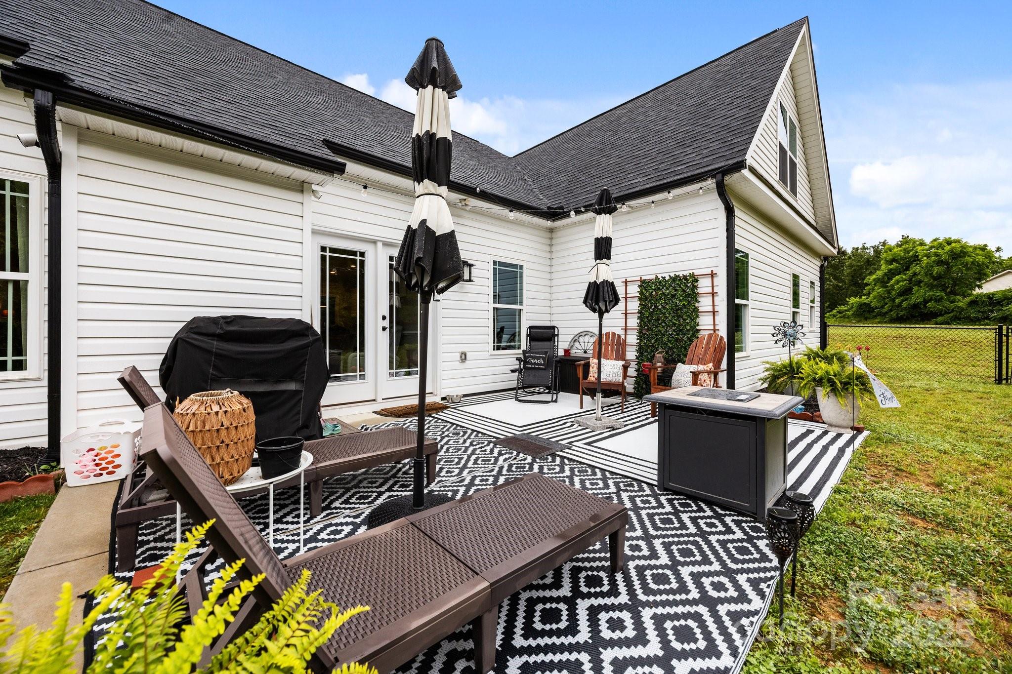3855 East Holly Grove Road Lexington, NC 27292 - Photo 34 of 42 a view of a patio with couches table and chairs and potted plants