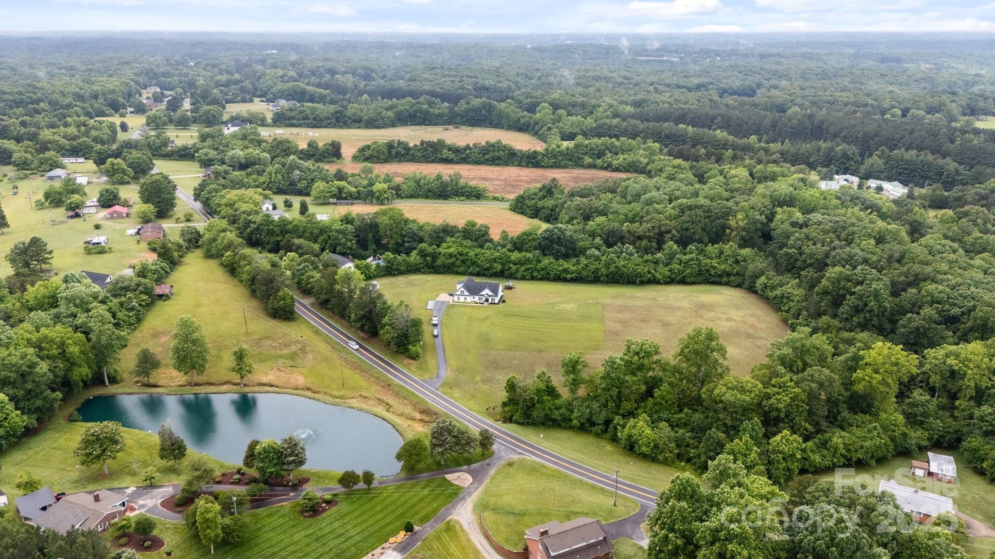 3855 East Holly Grove Road Lexington, NC 27292 - Photo 42 of 42 an aerial view of residential houses with outdoor space and lake view
