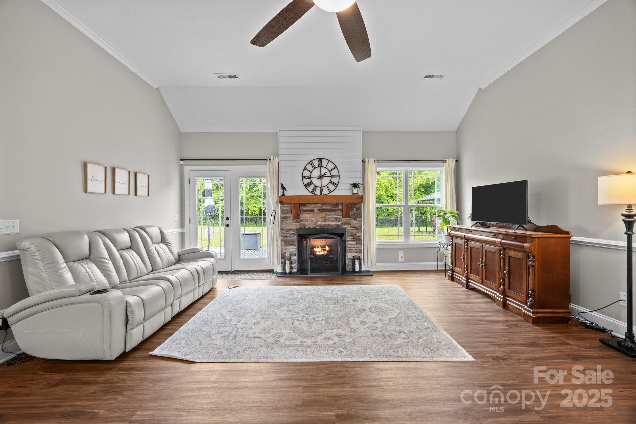 3855 East Holly Grove Road Lexington, NC 27292 - Photo 7 of 42 a living room with furniture a fireplace and a flat screen tv