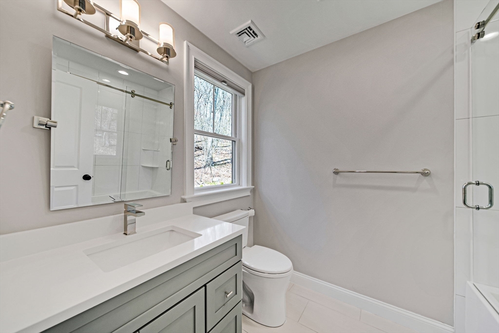 17 Sunrise Terrace Needham, MA 02492 - Photo 21 of 42 a bathroom with a sink a toilet and shower