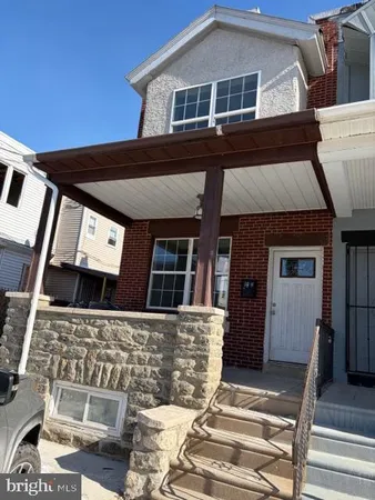 a front view of a house with many windows