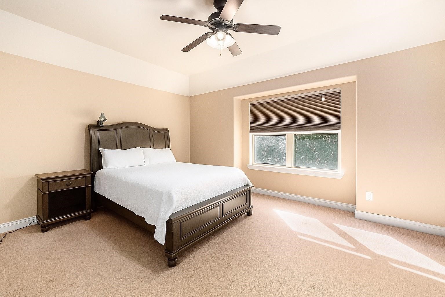 9039 Centennial Drive Conroe, TX 77384 - Photo 11 of 16 a bedroom with a bed and window