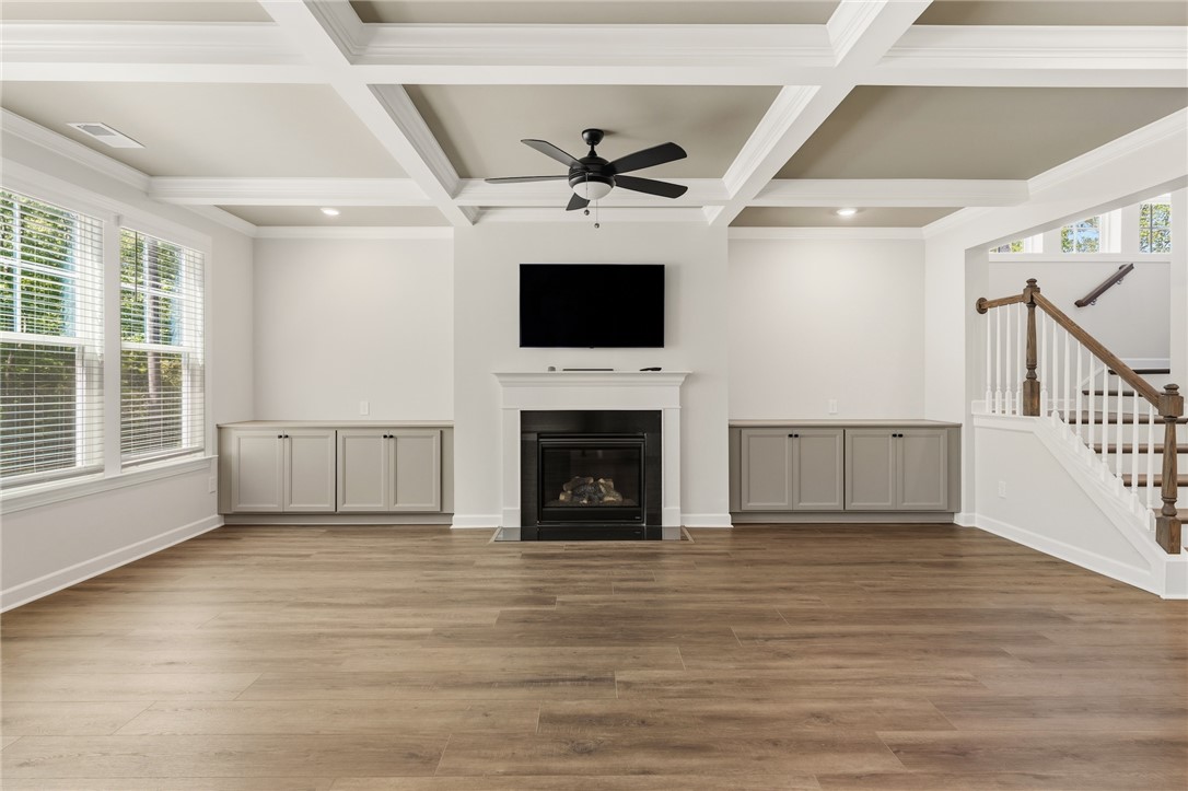 701 Weathered Oak Way Anderson, SC 29621 - Photo 9 of 41 This bright living area features a fireplace, built-in storage, and warm wood flooring.