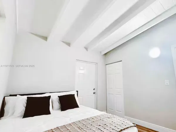 a bedroom with a bed and a lamp