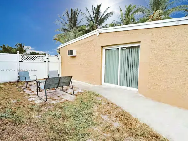 a view of a backyard with chairs