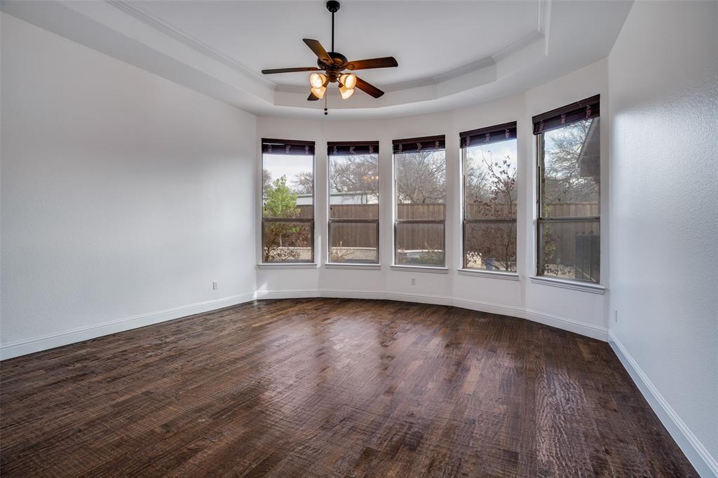 900 Jessica Lane Prosper, TX 75078 - Photo 17 of 40 a view of an empty room with wooden floor and a window