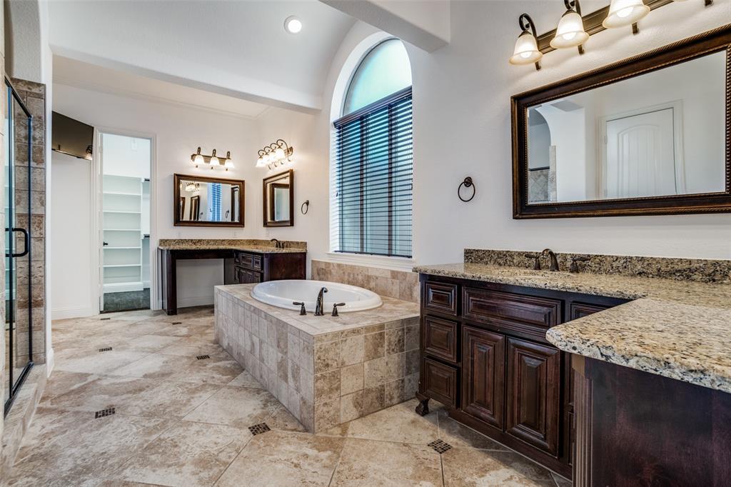 900 Jessica Lane Prosper, TX 75078 - Photo 18 of 40 a spacious bathroom with a granite countertop double vanity sink and a bathtub