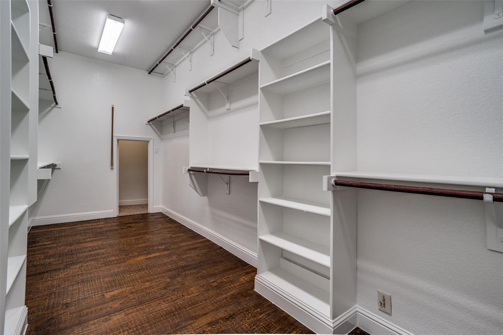 900 Jessica Lane Prosper, TX 75078 - Photo 19 of 40 Walk in closet featuring dark wood-style floors and extra safe room.