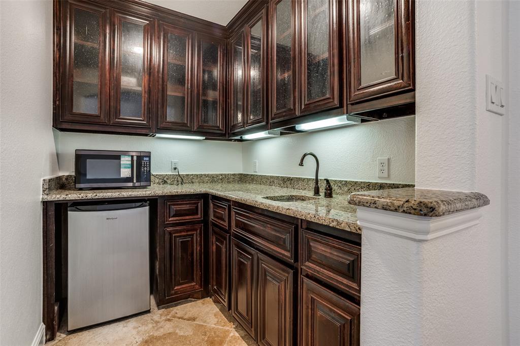 900 Jessica Lane Prosper, TX 75078 - Photo 20 of 40 a kitchen with stainless steel appliances granite countertop a sink stove and cabinets