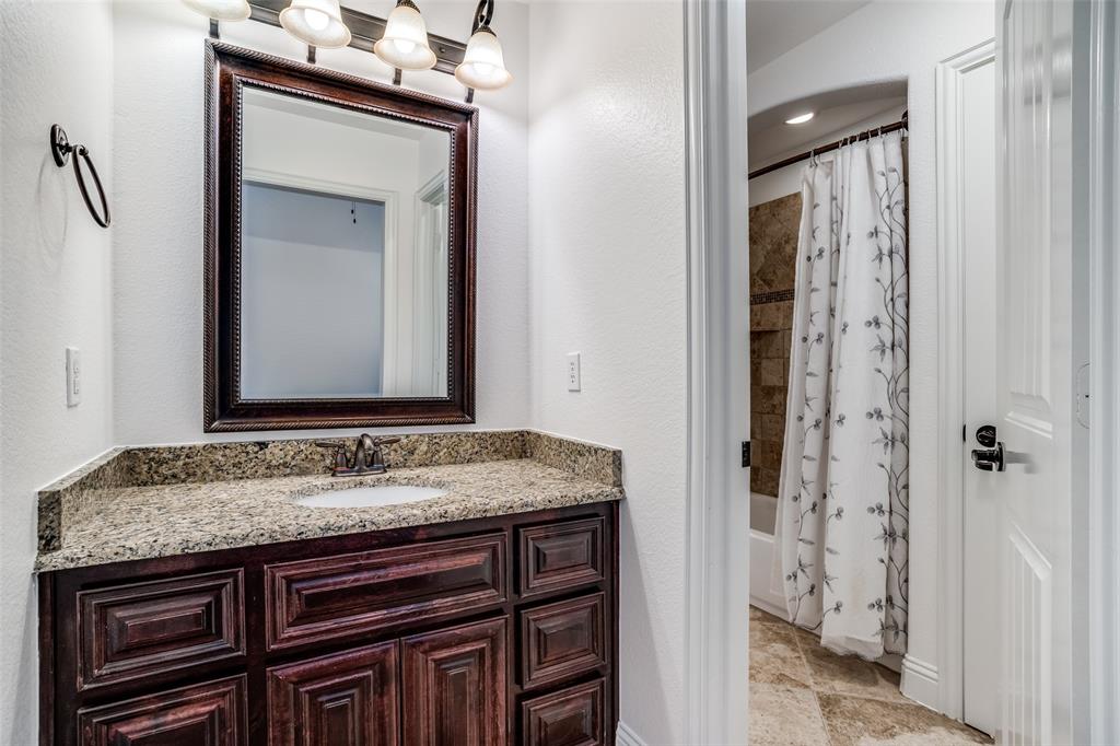 900 Jessica Lane Prosper, TX 75078 - Photo 27 of 40 a bathroom with a granite countertop sink and a mirror