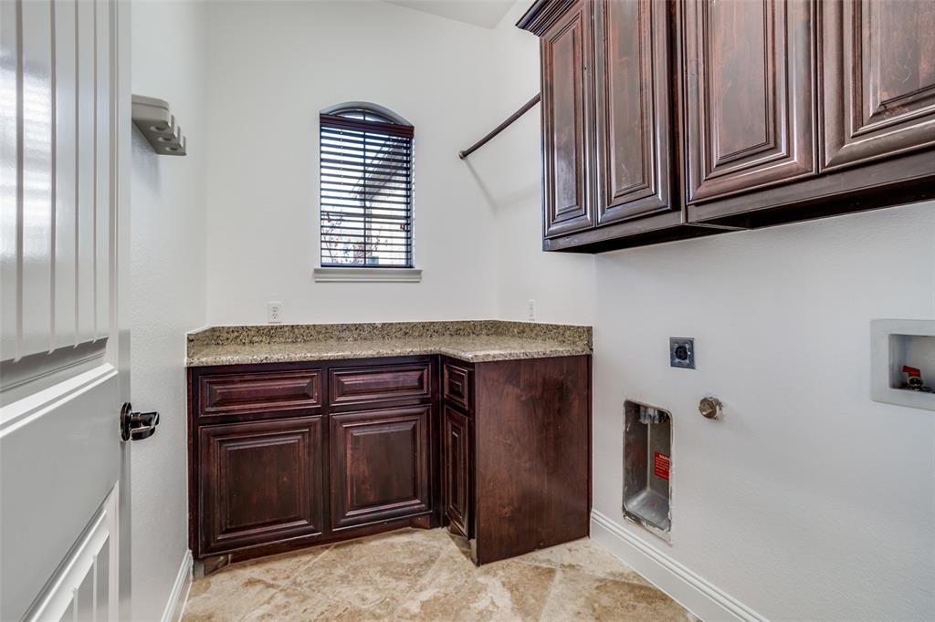 900 Jessica Lane Prosper, TX 75078 - Photo 30 of 40 a kitchen with stainless steel appliances granite countertop a stove and a microwave